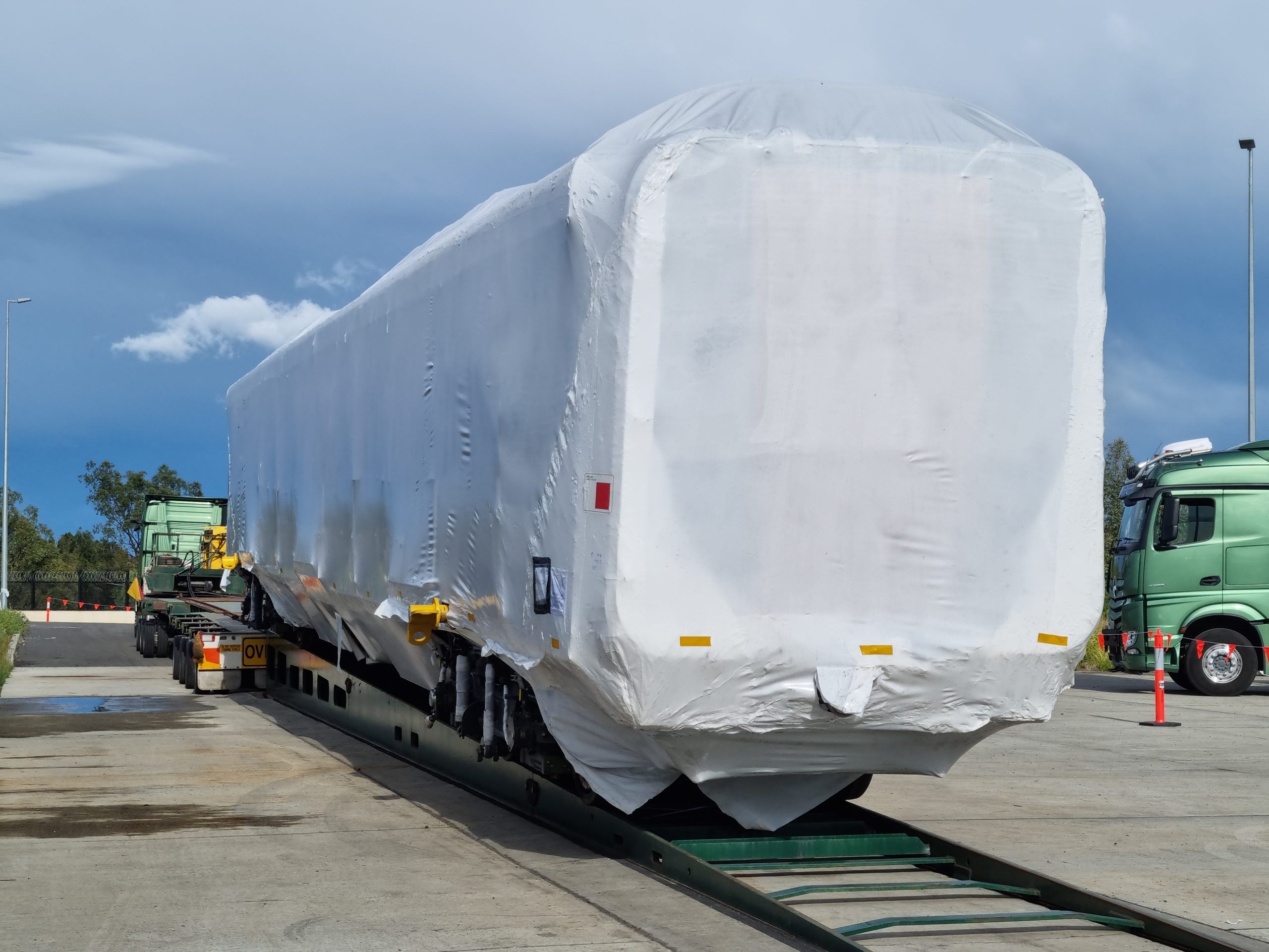 Passenger car being delivered to depot